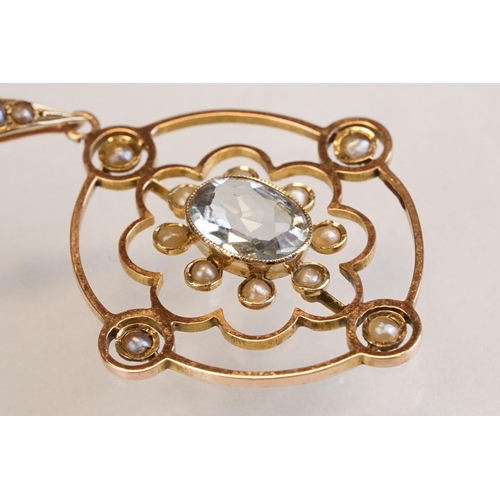 71 - Early 20th century aquamarine and seed pearl 9ct yellow gold pendant, the openwork design with oval ... 