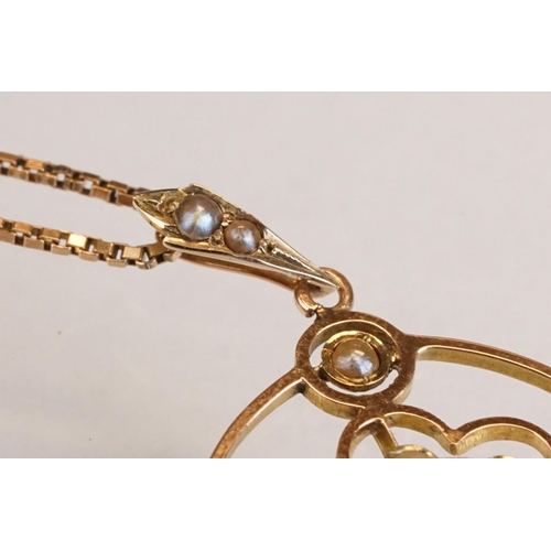 71 - Early 20th century aquamarine and seed pearl 9ct yellow gold pendant, the openwork design with oval ... 