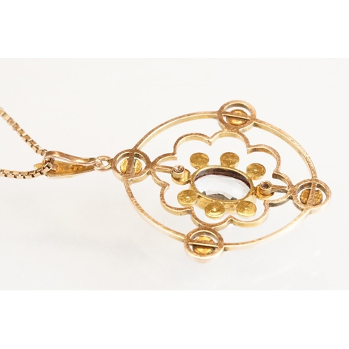 71 - Early 20th century aquamarine and seed pearl 9ct yellow gold pendant, the openwork design with oval ... 