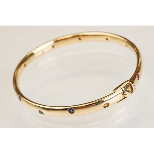 82 - Gem set 18ct yellow gold hinged bangle, pink, blue and yellow small round brilliant cut sapphires an... 