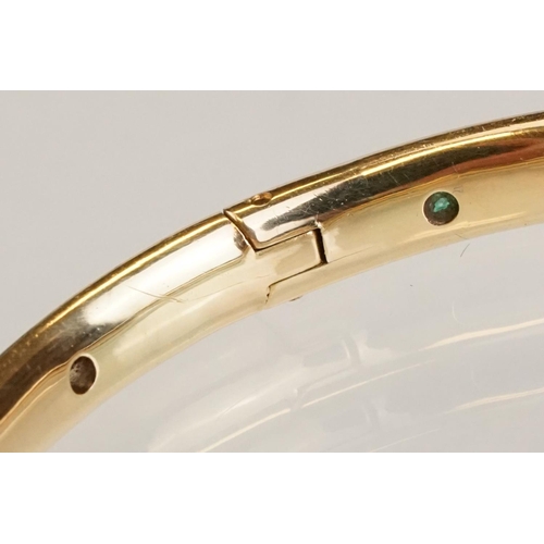 82 - Gem set 18ct yellow gold hinged bangle, pink, blue and yellow small round brilliant cut sapphires an... 