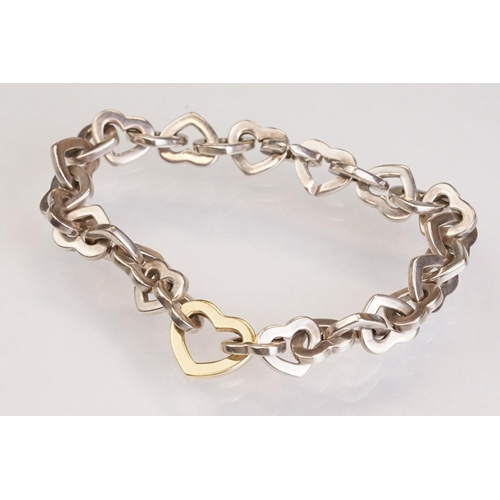 83 - Tiffany & Co parcel gilt silver heart shaped link bracelet, the centre heart gold plated, the clasp ... 