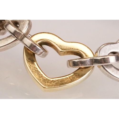 83 - Tiffany & Co parcel gilt silver heart shaped link bracelet, the centre heart gold plated, the clasp ... 