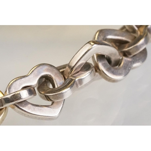 83 - Tiffany & Co parcel gilt silver heart shaped link bracelet, the centre heart gold plated, the clasp ... 