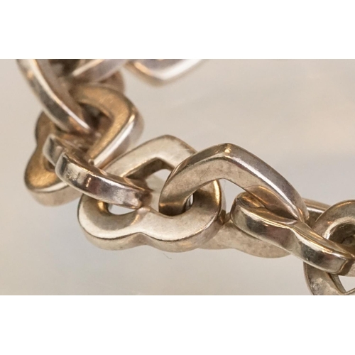 83 - Tiffany & Co parcel gilt silver heart shaped link bracelet, the centre heart gold plated, the clasp ... 