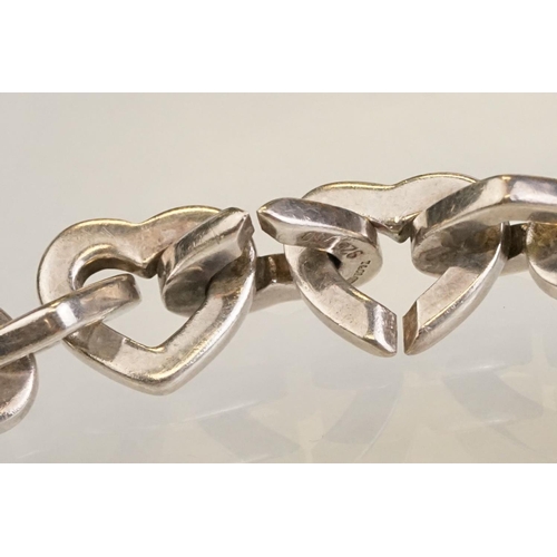 83 - Tiffany & Co parcel gilt silver heart shaped link bracelet, the centre heart gold plated, the clasp ... 