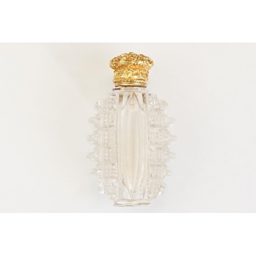 85 - Victorian scent bottle with yellow metal hinged lid, cut glass body of flattened oval form and stopp... 