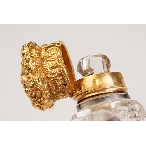 85 - Victorian scent bottle with yellow metal hinged lid, cut glass body of flattened oval form and stopp... 