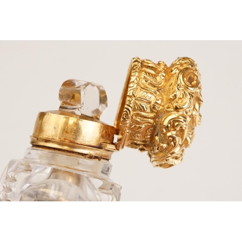 85 - Victorian scent bottle with yellow metal hinged lid, cut glass body of flattened oval form and stopp... 