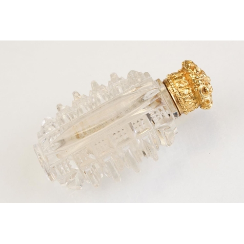 85 - Victorian scent bottle with yellow metal hinged lid, cut glass body of flattened oval form and stopp... 