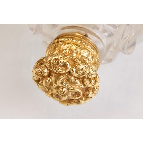 85 - Victorian scent bottle with yellow metal hinged lid, cut glass body of flattened oval form and stopp... 