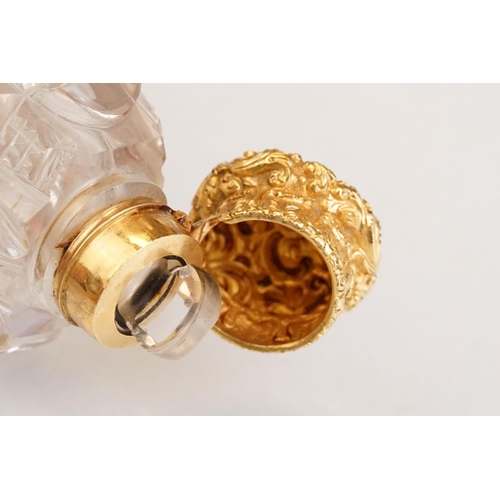 85 - Victorian scent bottle with yellow metal hinged lid, cut glass body of flattened oval form and stopp... 