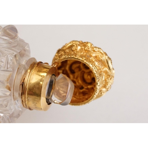 85 - Victorian scent bottle with yellow metal hinged lid, cut glass body of flattened oval form and stopp... 