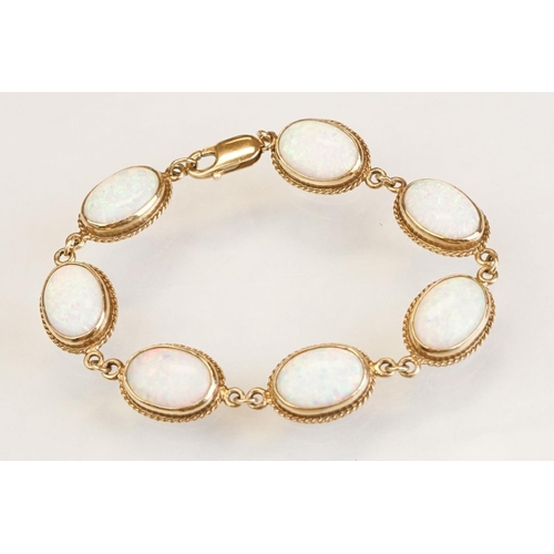 90 - Opal 9ct yellow gold bracelet, seven oval cabochon probably synthetic white opals, dimensions approx... 