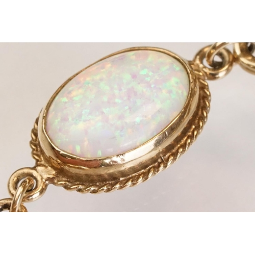 90 - Opal 9ct yellow gold bracelet, seven oval cabochon probably synthetic white opals, dimensions approx... 