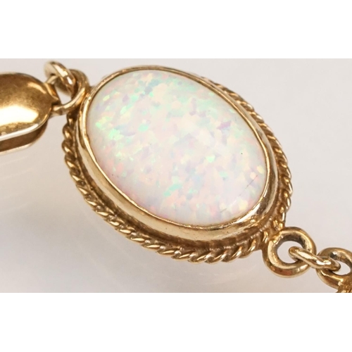 90 - Opal 9ct yellow gold bracelet, seven oval cabochon probably synthetic white opals, dimensions approx... 