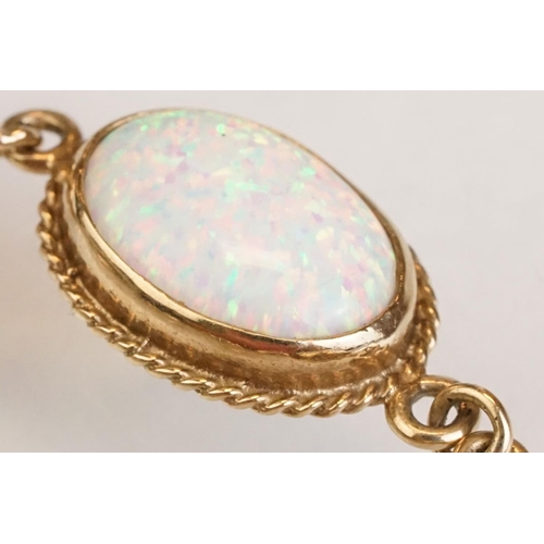 90 - Opal 9ct yellow gold bracelet, seven oval cabochon probably synthetic white opals, dimensions approx... 