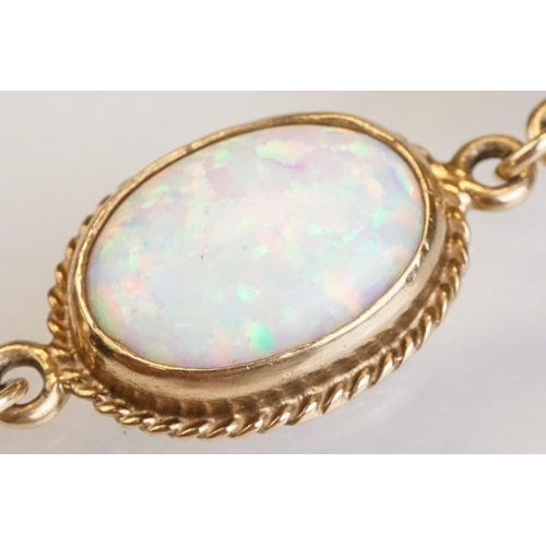 90 - Opal 9ct yellow gold bracelet, seven oval cabochon probably synthetic white opals, dimensions approx... 