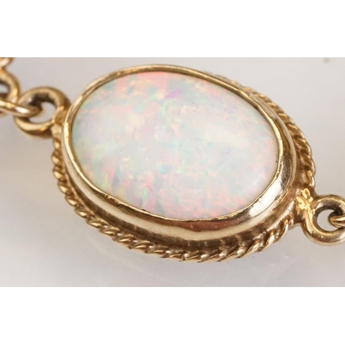 90 - Opal 9ct yellow gold bracelet, seven oval cabochon probably synthetic white opals, dimensions approx... 