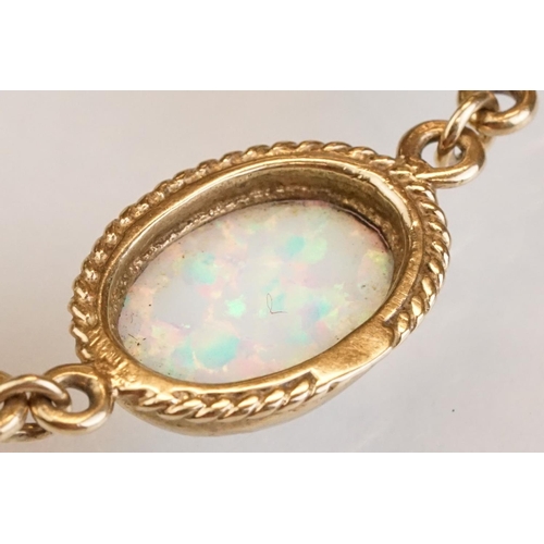 90 - Opal 9ct yellow gold bracelet, seven oval cabochon probably synthetic white opals, dimensions approx... 
