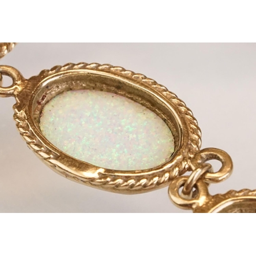 90 - Opal 9ct yellow gold bracelet, seven oval cabochon probably synthetic white opals, dimensions approx... 