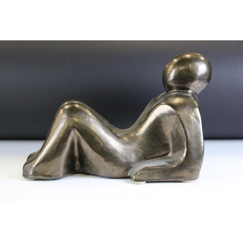 123 - Ceramic modernist sculpture in the form of a stylised recumbent figure. Unsigned. Measures 34cm wide... 