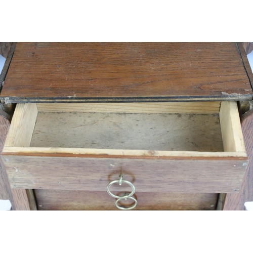 130 - Early 20th Century oak desk top chest of drawers / desk tidy having a sliding panel to the front wit... 