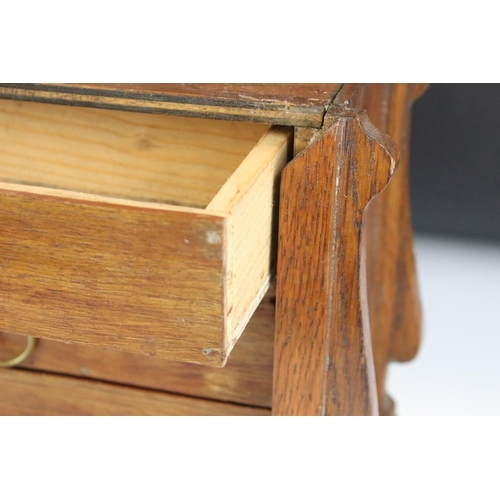 130 - Early 20th Century oak desk top chest of drawers / desk tidy having a sliding panel to the front wit... 