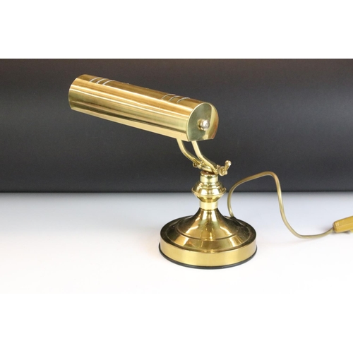 132 - Brass bankers style lamp having a round base with adjustable arm and cylindrical brass shade to the ... 