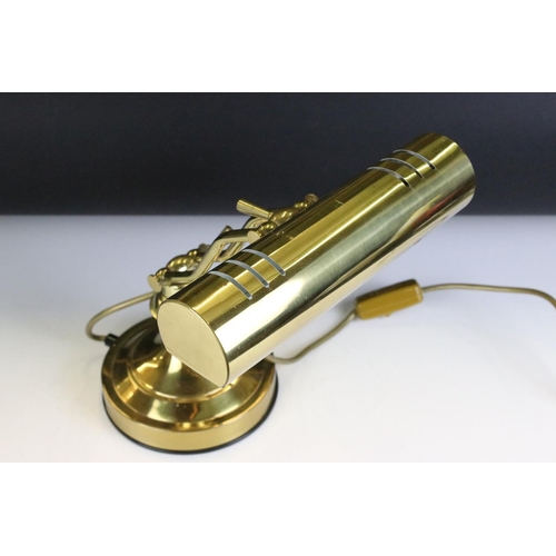 132 - Brass bankers style lamp having a round base with adjustable arm and cylindrical brass shade to the ... 