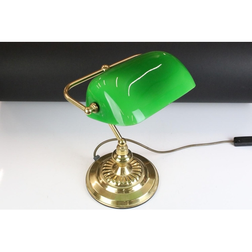 133 - Brass bankers style lamp having a round stepped base with a green shade to the top. Measures 37cm ta... 