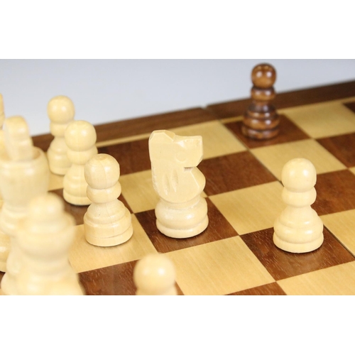 134 - Jaques London folding wooden chess board having a full set of matching turned wooden chess pieces. K... 