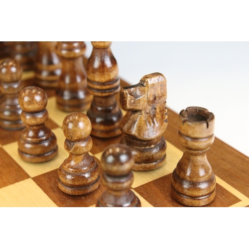 134 - Jaques London folding wooden chess board having a full set of matching turned wooden chess pieces. K... 