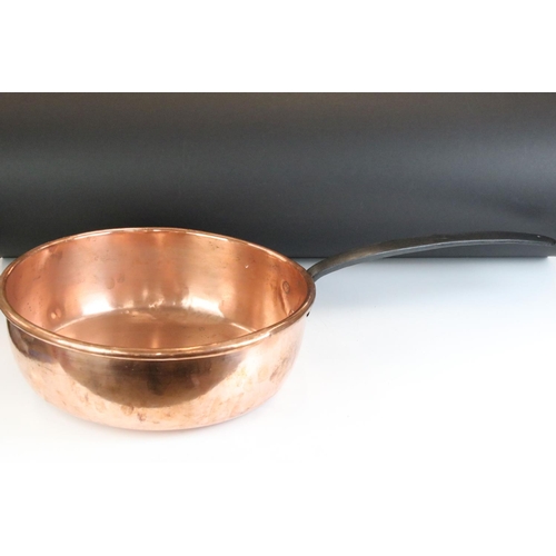 135 - Large 19th Century copper sauce pan having a cast iron handle. Measures 37cm diameter.