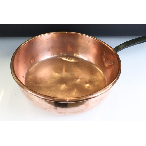 135 - Large 19th Century copper sauce pan having a cast iron handle. Measures 37cm diameter.