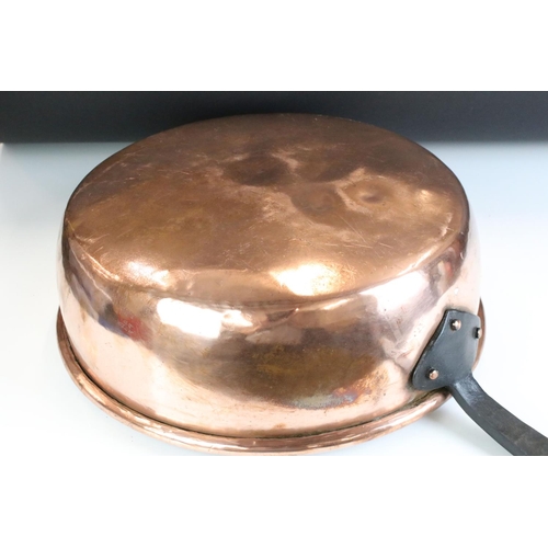 135 - Large 19th Century copper sauce pan having a cast iron handle. Measures 37cm diameter.