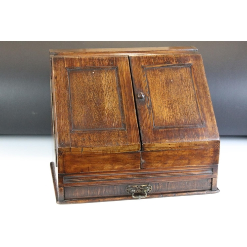 140 - 19th century oak stationery cabinet with fold-out doors, lower drawer with brass drop handle, and in... 