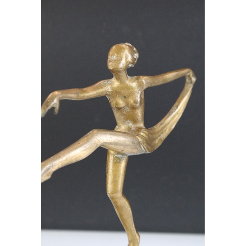 142 - Art Deco gilt metal table lighter in the form of a semi-nude lady dancer raised upon a globe, green ... 
