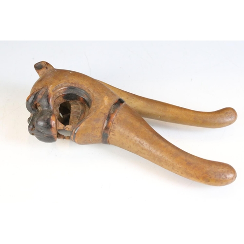 145 - 19th century carved treen nutcracker in the form of a dog baring its teeth, approx 21cm long