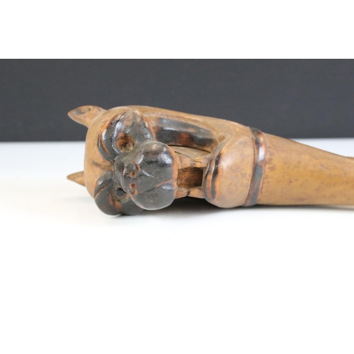 145 - 19th century carved treen nutcracker in the form of a dog baring its teeth, approx 21cm long