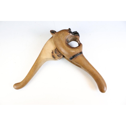145 - 19th century carved treen nutcracker in the form of a dog baring its teeth, approx 21cm long