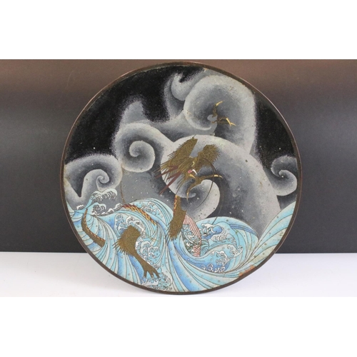 146 - Chinese cloisonne charger decorated with a dragon amongst waves and clouds, floral decoration on blu... 
