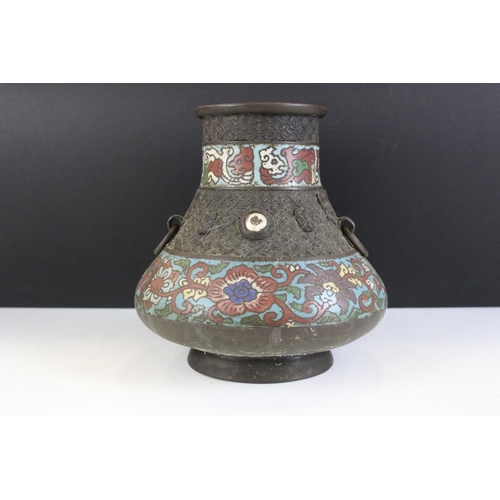 151 - Chinese bronze champleve enamel twin-handled vase of squat baluster form, the enamel bands with flor... 