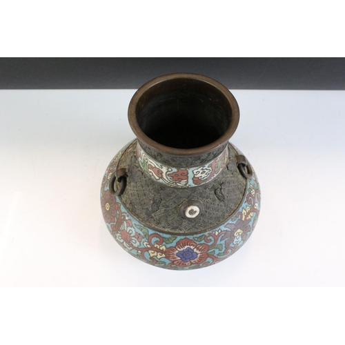 151 - Chinese bronze champleve enamel twin-handled vase of squat baluster form, the enamel bands with flor... 