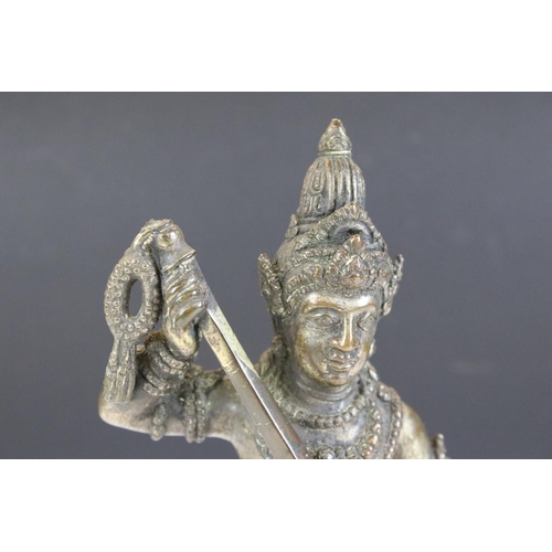 154 - Hindu bronze figure of a deity stood holding a weapon, approx 19cm high