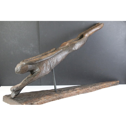 173 - Jude Lamb - Late 20th Century carved oak sculpture in the form of a leaping hare raised on a natural... 