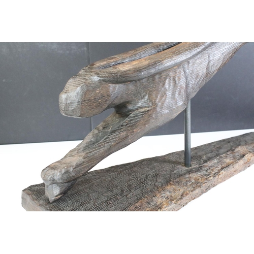 173 - Jude Lamb - Late 20th Century carved oak sculpture in the form of a leaping hare raised on a natural... 