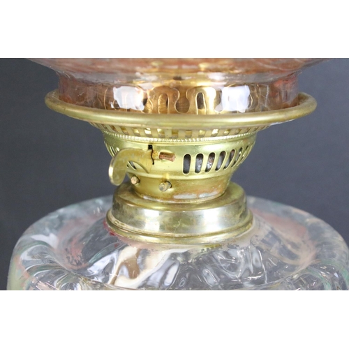175 - 19th Century Victorian brass and glass oil lamp having a clear glass reservoir raised on a brass col... 