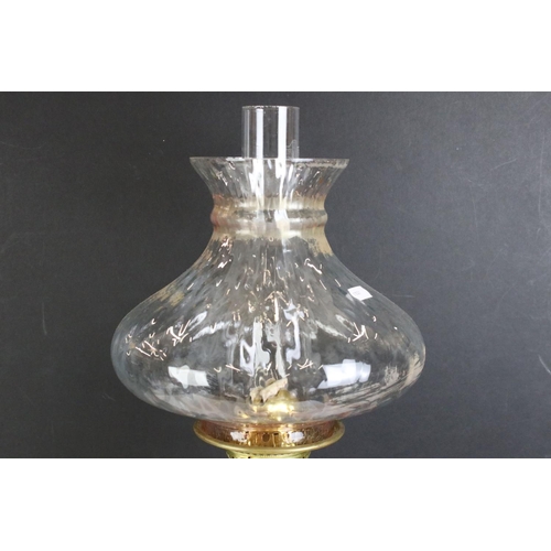 175 - 19th Century Victorian brass and glass oil lamp having a clear glass reservoir raised on a brass col... 