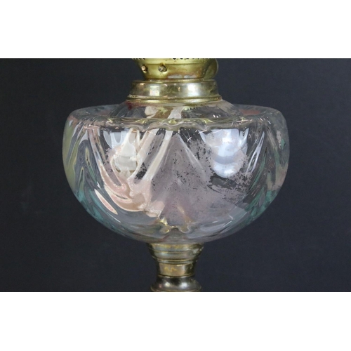 175 - 19th Century Victorian brass and glass oil lamp having a clear glass reservoir raised on a brass col... 